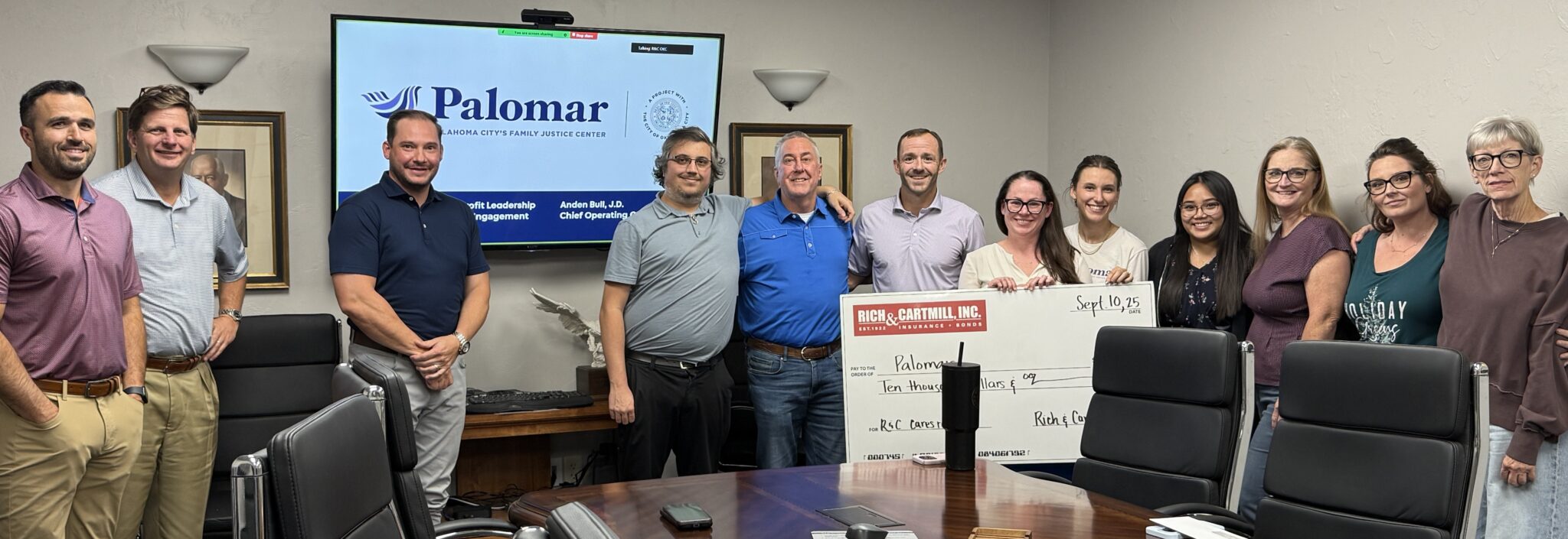 Group photo of Palomat team accepting Rich & Cartmill. Inc R&C Cares donation.