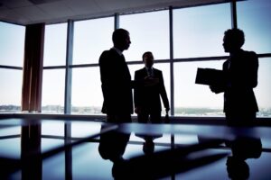 business owners reviewing insurance coverage in office meeting